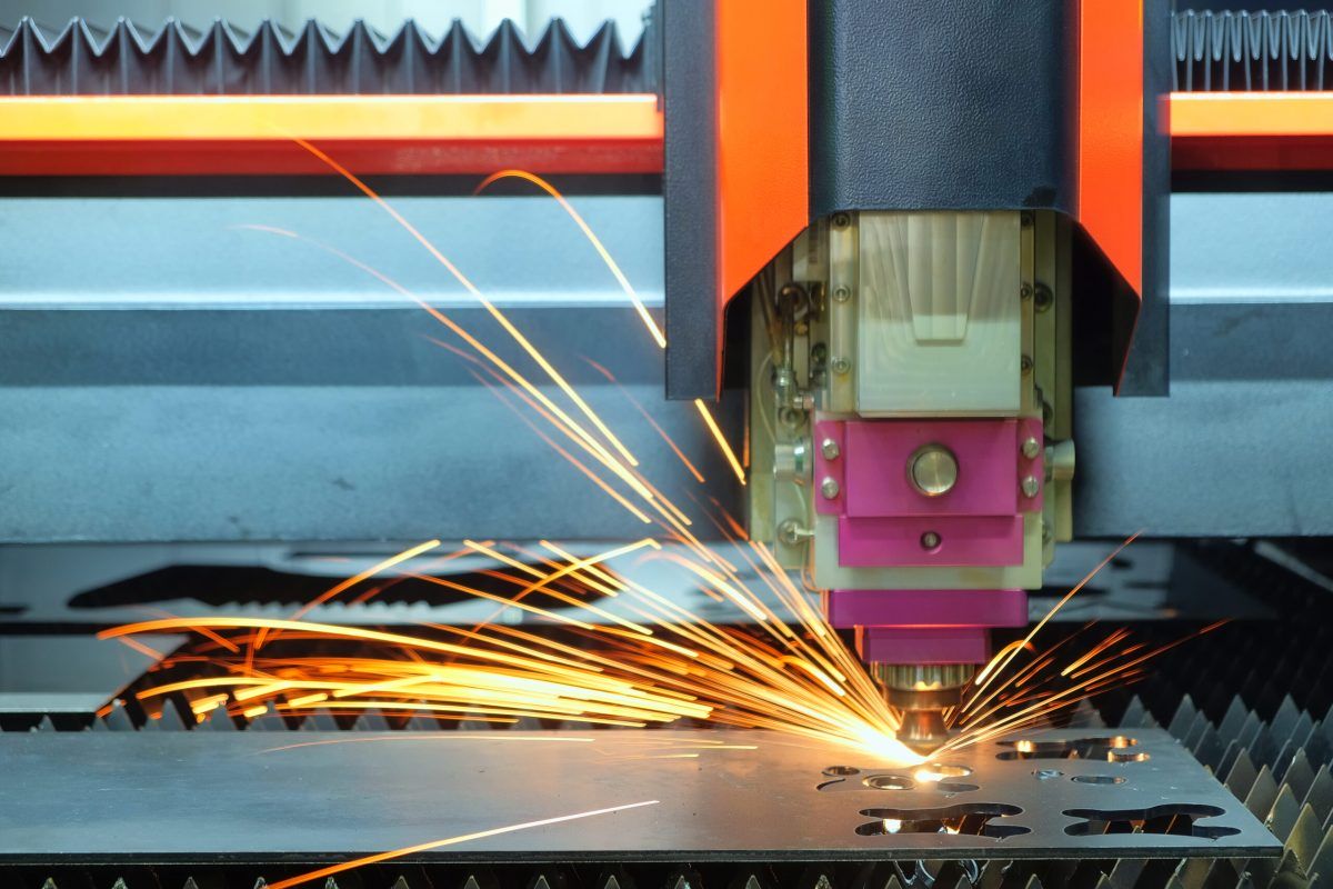 close-up-laser-cutting-machine-is-working-with-steel-plate-until-it-sparks-smart-factory